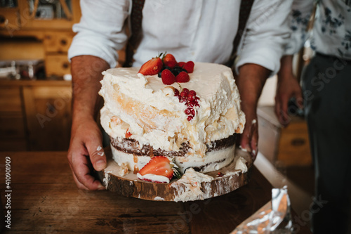 photo of a smashed homemade white strawberries cake