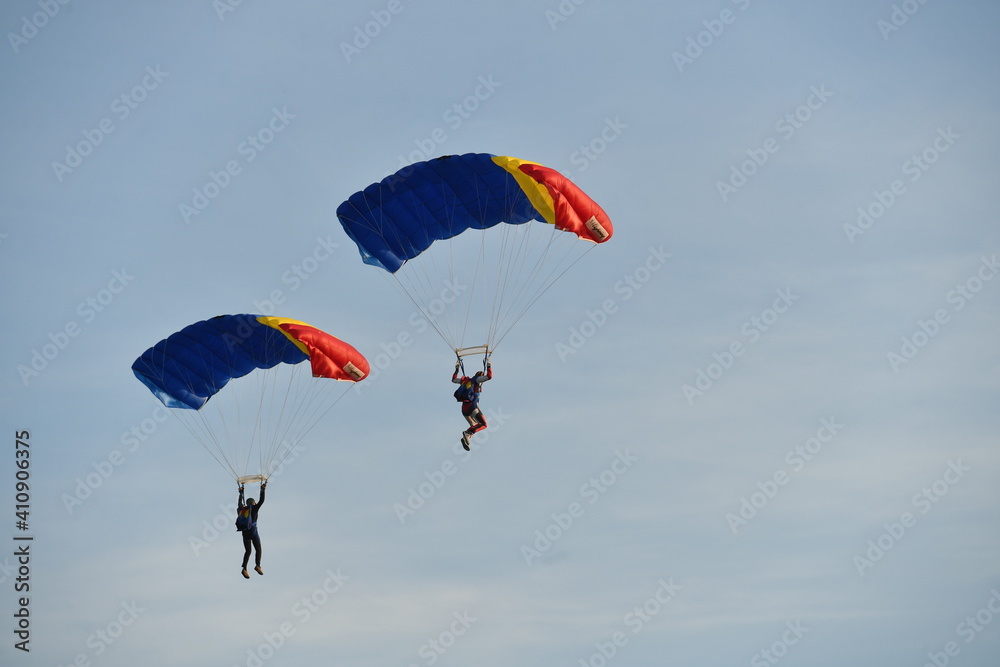 Parachute jumper. Romanian parachutist holding the Romanian flag in his hand. Parachute jumper. Romanian parachutist holding the Romanian flag in his hand.