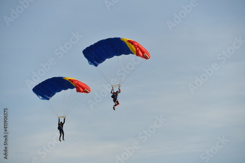 Parachute jumper. Romanian parachutist holding the Romanian flag in his hand.