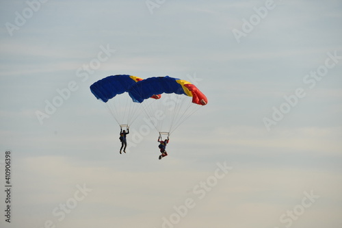 Parachute jumper. Romanian parachutist holding the Romanian flag in his hand.