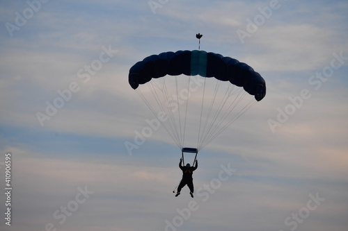  Parachute jumper. Romanian parachutist holding the Romanian flag in his hand.