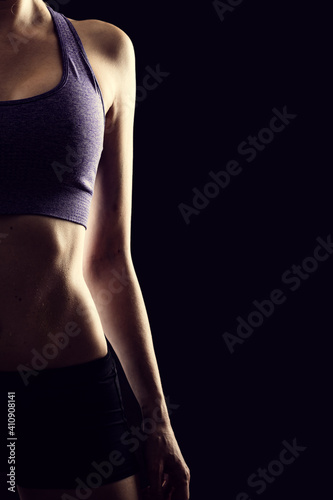 Slim beauty athletic woman on black background