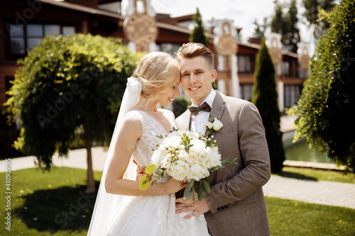 Happy beautiful wedding couple bride and groom at wedding day outdoors . Portrait of a beautiful young wedding couple