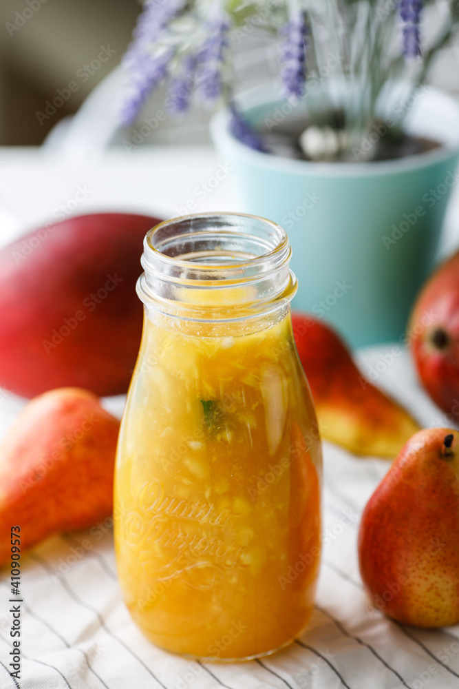 citrus tea with mango and pear in a glass jar citrus tea with mango and pear in a glass jar