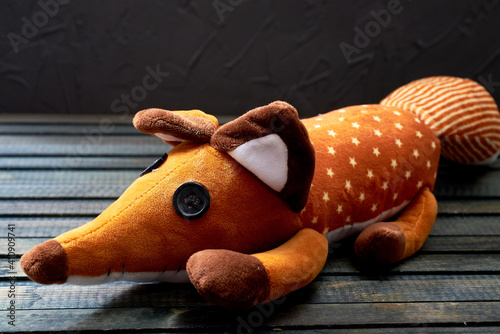 toy Fox from the cartoon The Little Prince on a dark wooden background photo