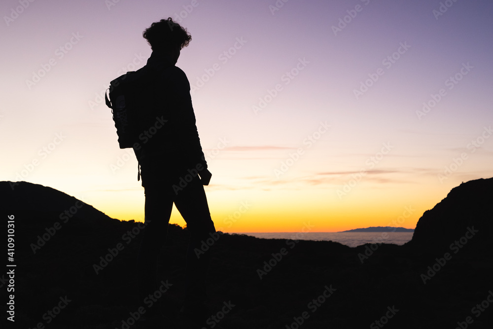 Traveler Watching Sunset over the Atlantic Ocean.