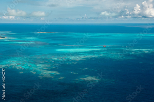 Exceptional view of coral reefs with its clear blue and green waters seen from the plane