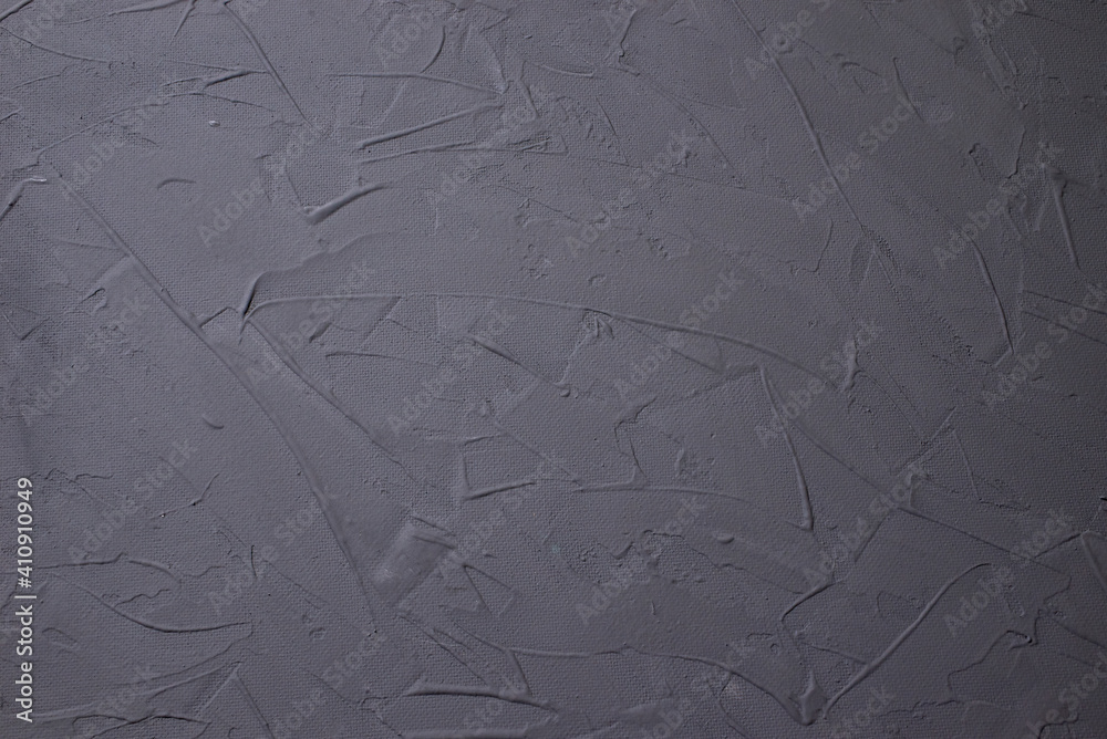 a dark gray stucco wall. abstract pattern