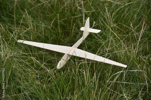Toy airplane left by the child in the green grass.