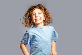 little girl jumps on a gray background