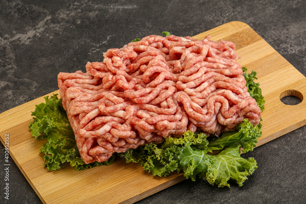 Raw pork minced meat over board Raw pork minced meat over board