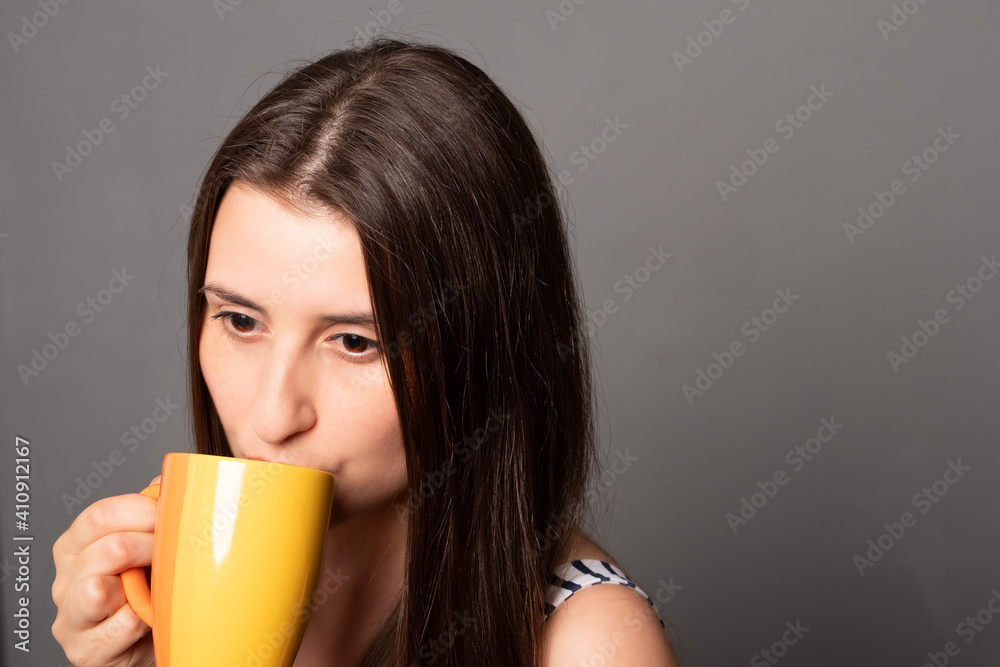 Young woman with a coffee mug. Beautiful woman is drinking coffee. Young woman with a coffee mug. Beautiful woman is drinking coffee.