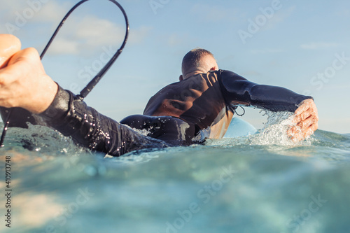 Mature man surfing in the sea