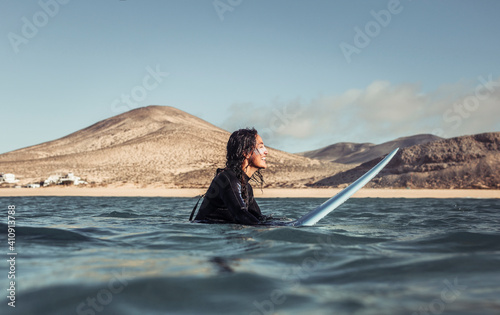 Woman surfing in the sea with a yellow surfboard