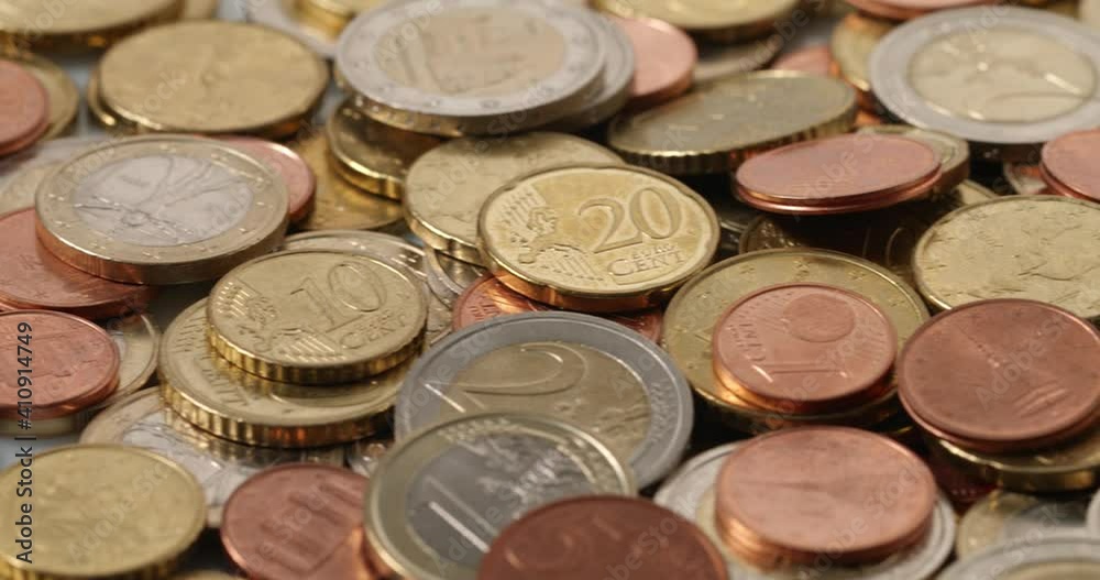 Closeup of pile of Euros. Euro coins One and Two coins, surrounded by lower denomination Coins. Gold, Silver and Bronze Closeup of pile of Euros. Euro coins One and Two coins, surrounded by lower denomination Coins. Gold, Silver and Bronze