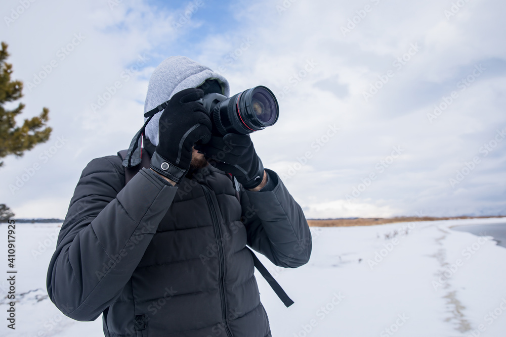 man holding camera in winter day man holding camera in winter day