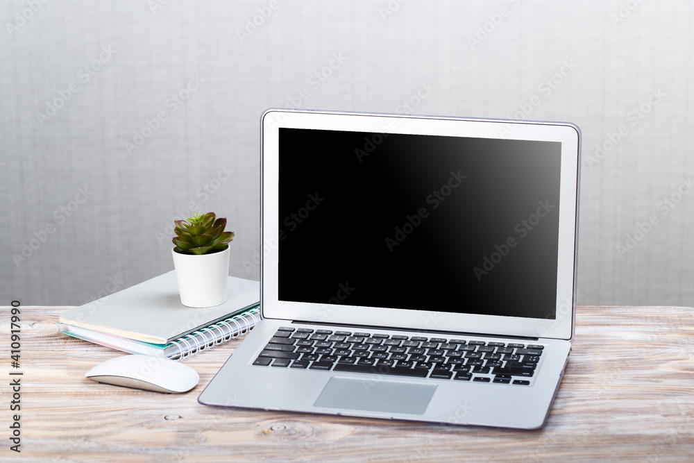 mocap Laptop and books and white computer mouse on a wooden table. mocap Laptop and books and white computer mouse on a wooden table.