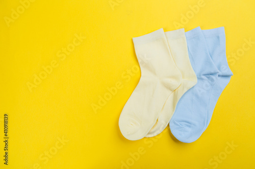 View from above. Socks are scattered on a yellow background. Clothing in the form of socks.