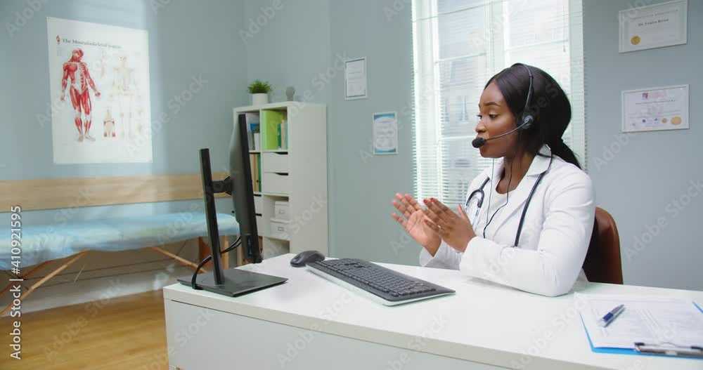 African female doctor wear headset make online video call consult patient. Afro american black woman therapist videoconferencing talking to camera in remote chat. Telemedicine, telehealth. African female doctor wear headset make online video call consult patient. Afro american black woman therapist videoconferencing talking to camera in remote chat. Telemedicine, telehealth.