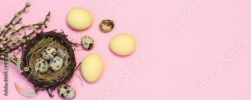 easter composition with yellow painted eggs and willow twigs