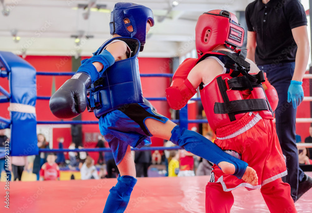 boxers in the ring. Boxer in full gear. Children's sports. Thai boxing. Boxing competition. Kick. boxers in the ring. Boxer in full gear. Children's sports. Thai boxing. Boxing competition. Kick.