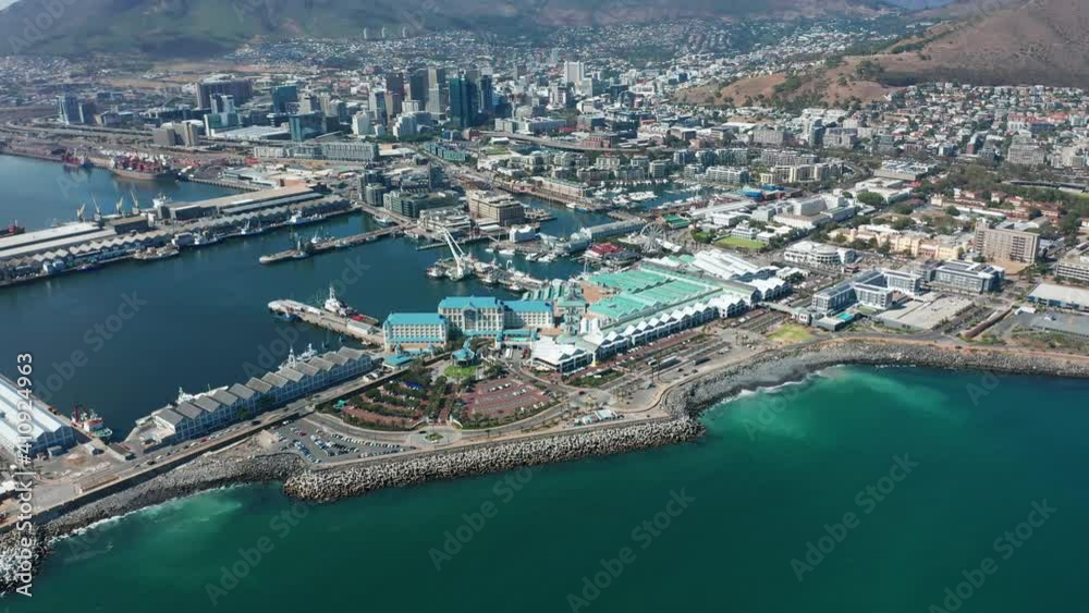 Wide aerial shot tracking forward into the city of Cape Town during a spectacular sunrise with Table Mountain in the background. Wide aerial shot tracking forward into the city of Cape Town during a spectacular sunrise with Table Mountain in the background.