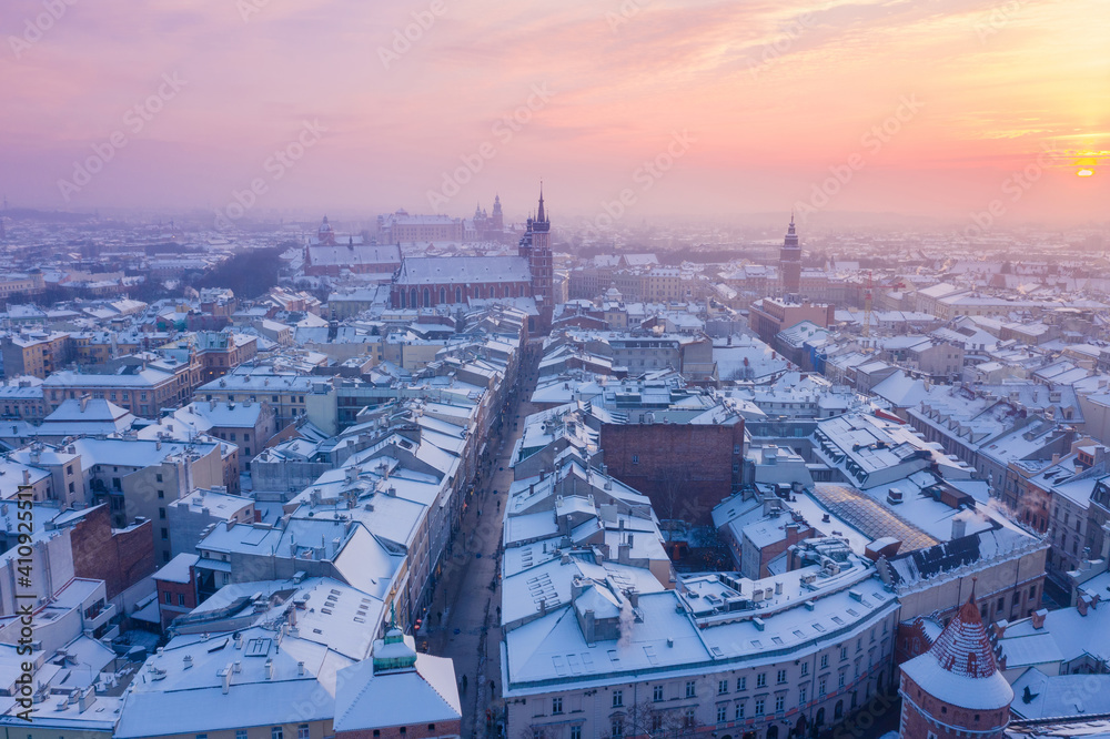 Krakow Old Town in winter. Snow on roofs at Old Town in winter Krakow Poland at sunset. Historical main city square Rynek, Royal Road and churches. Snow on roofs in winter Krakow Poland at sunset.