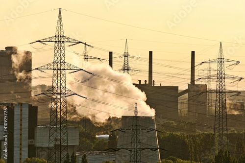 high voltage pylon and industry landscape chimneys smoke