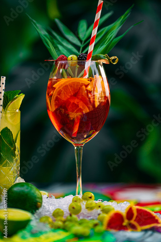 tropical cocktail with berries and fruits on a decorated table