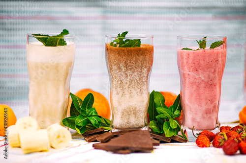 milkshake with berries and fruits on a decorated table