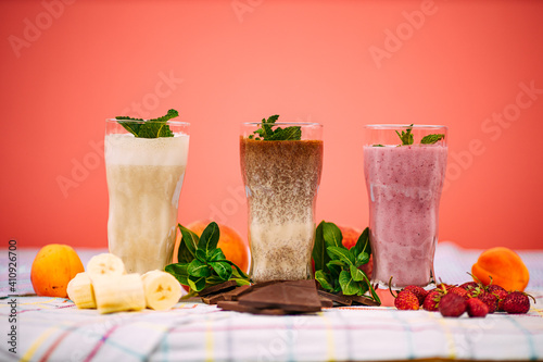 milkshake with berries and fruits on a decorated table