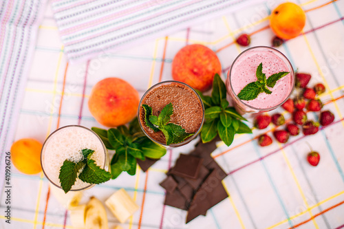 milkshake with berries and fruits on a decorated table