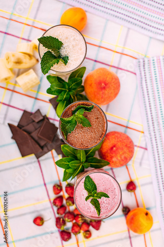 milkshake with berries and fruits on a decorated table