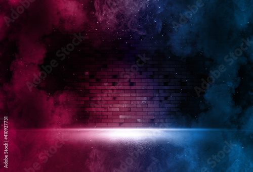Searchlight on neon brick wall with smoke. Neon reflections on wet asphalt. Empty scene with copy space.