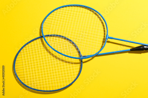 Badminton rackets on yellow background, above view © New Africa