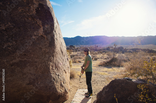 Cool Climber Guide in boulder landscape. 