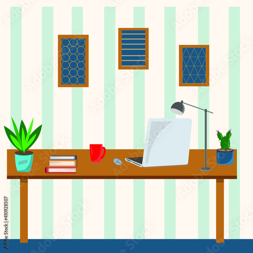 workplace at home with laptop, books, cup of tea