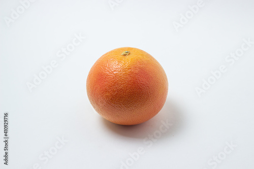 Grapefruit on a white background. One whole grapefruit. Citrus fruit. Exotic fruit