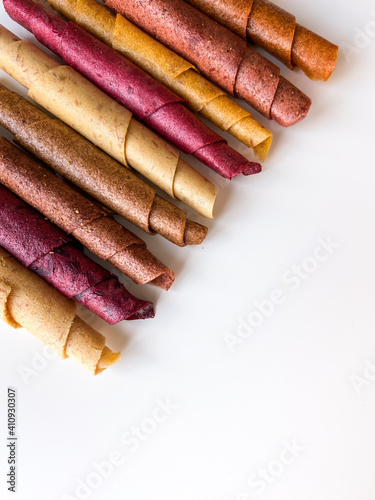 Fruit leather roll, pastille isolated on white background. Healthy snack food, natural nutrition for kids.