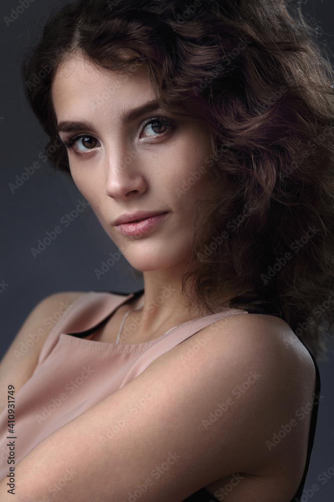 Studio portrait of a beautiful girl on a gray background Studio portrait of a beautiful girl on a gray background