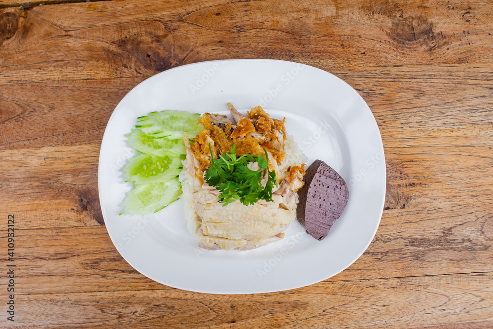 Fried chicken and boiled chicken with rice on a white plate 
