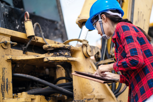 A female engineer is inspecting work at the construction site.