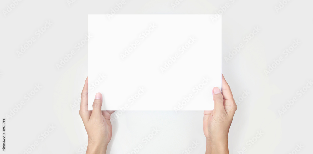 Hands holding paper blank for letter paper Hands holding paper blank for letter paper
