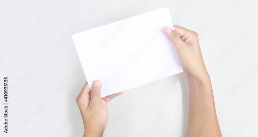 Hands holding paper blank for letter paper Hands holding paper blank for letter paper