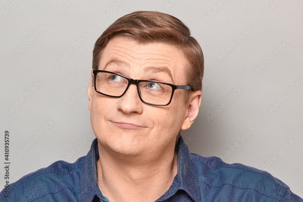 Portrait of happy man with glasses looking dreamily aside Portrait of happy man with glasses looking dreamily aside