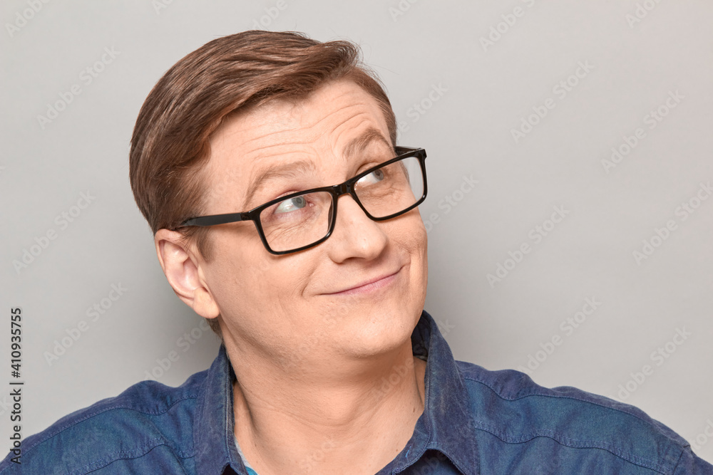Portrait of happy man with glasses looking dreamily aside Portrait of happy man with glasses looking dreamily aside