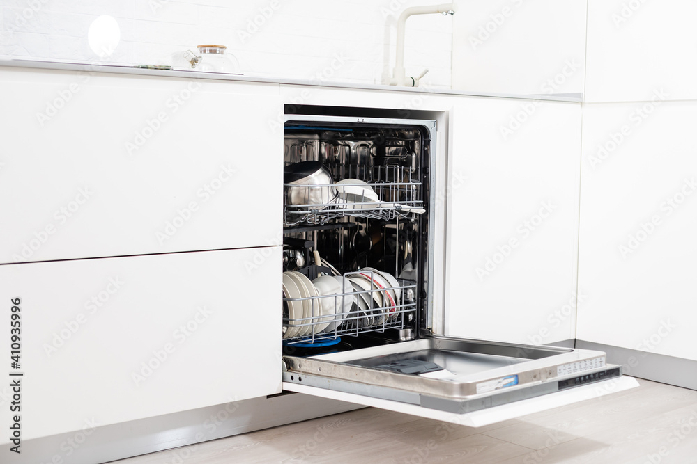 Picture of an opened dishwasher in the kitchen Picture of an opened dishwasher in the kitchen