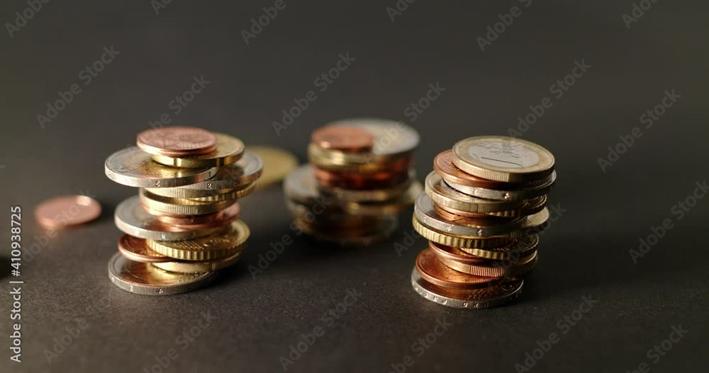 Euro Coins Stacked, panning shot of Money Coins from European Union on Dark Background Euro Coins Stacked, panning shot of Money Coins from European Union on Dark Background