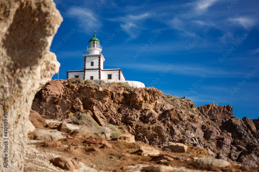 19th-century lighthouse - Akrotiri Lighthouse - on rocky hill on Santorini Island, Greece, Cyclades. Famous landmark in Akrotiri village