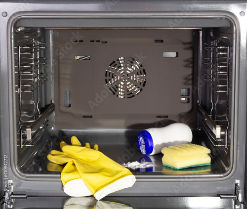 Cleaning a dirty oven. Gloves and oven cleaners